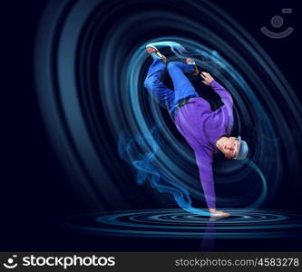 Modern style dancer. Modern style dancer posing against dark background with light effects. Illustration