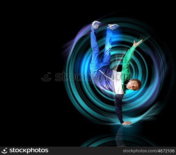 Modern style dancer. Modern style dancer posing against dark background with light effects. Illustration