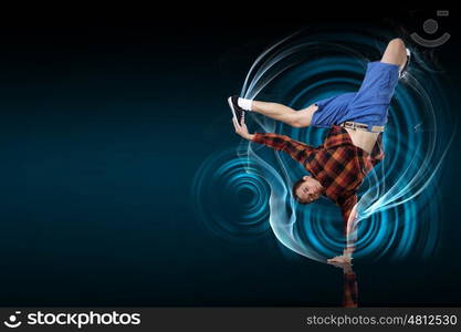 Modern style dancer. Modern style dancer posing against dark background with light effects. Illustration