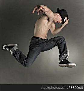 modern style dancer posing on grunge grey background