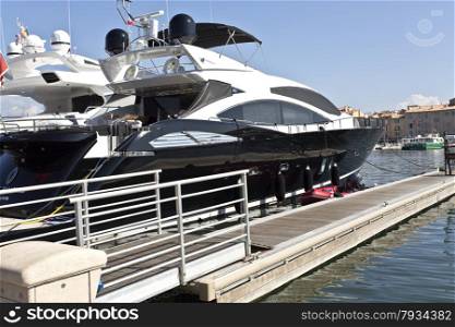 Modern super luxury yachts at port in St. Tropez, France. They are the toys of the famous and super rich.