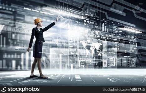 Modern technologies in use. Attractive engineer woman using modern media technologies