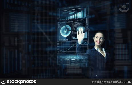 Modern technologies in use. Attractive smiling businesswoman working with virtual panel interface