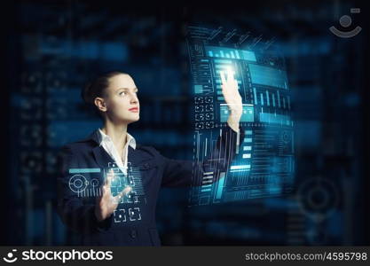 Modern technologies in use. Attractive smiling businesswoman working with virtual panel interface