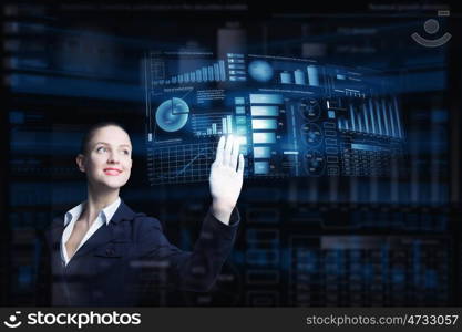 Modern technologies in use. Attractive smiling businesswoman working with virtual panel interface