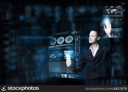 Modern technologies in use. Attractive smiling businesswoman working with virtual panel interface