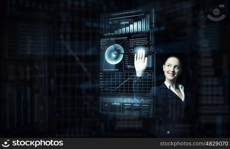 Modern technologies in use. Attractive smiling businesswoman working with virtual panel interface