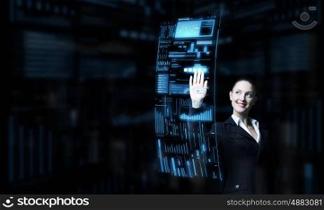 Modern technologies in use. Attractive smiling businesswoman working with virtual panel interface