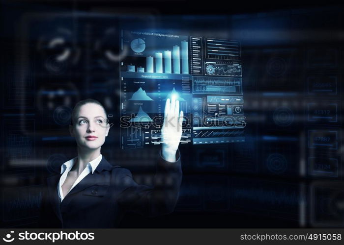 Modern technologies in use. Attractive smiling businesswoman working with virtual panel interface