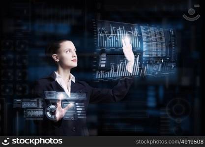 Modern technologies in use. Attractive smiling businesswoman working with virtual panel interface