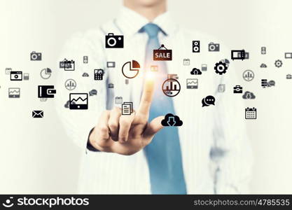 Modern technologies in use. Hand of businessman pushing with finger icon on media interface