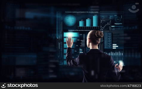 Modern technologies in use. Rear view of businesswoman working with virtual panel interface