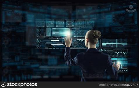 Modern technologies in use. Rear view of businesswoman working with virtual panel interface