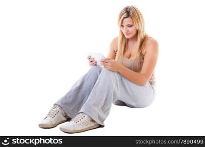 Modern technologies leisure and lifestyle concept. Young woman casual style girl sitting on floor with computer tablet isolated on white