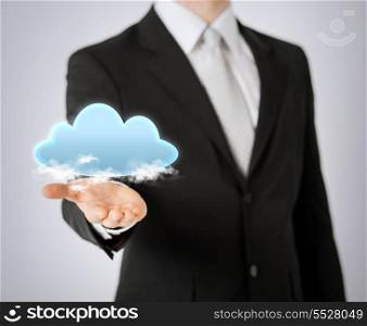 modern technology and cloud computing concept - close up of mans hand showing cloud