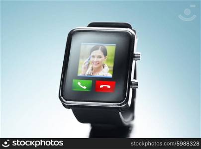 modern technology, communication, object and media concept - close up of black smart watch with video call contact icon and buttons over blue background