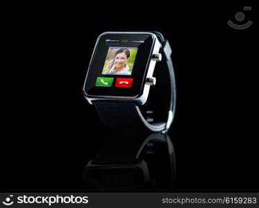 modern technology, communication, object and media concept - close up of black smart watch with incoming call interface on screen
