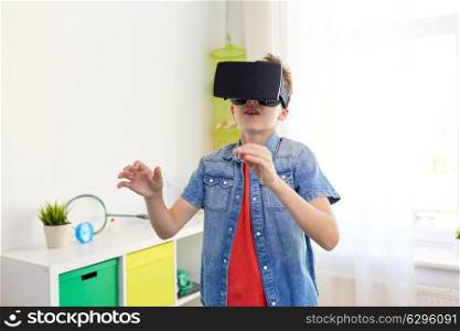 modern technology, gaming and people concept - boy in virtual reality headset or 3d glasses playing videogame at home. boy in virtual reality headset or 3d glasses