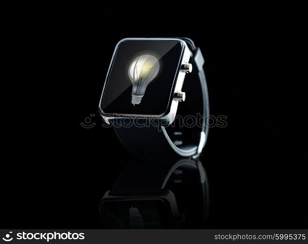 modern technology, idea, inspiration and object concept - close up of black smart watch light bulb on screen