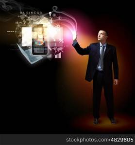 Modern technology in business. Businessman standing with modern technology symbols next to him