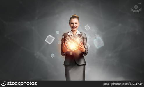 Modern technology integration concept. Attractive businesswoman shows 3D cube illustration as symbol of modern technology