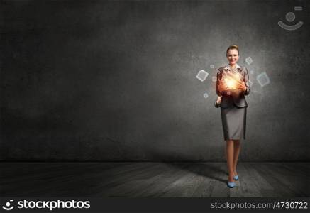 Modern technology integration concept. Attractive businesswoman shows 3D cube illustration as symbol of modern technology