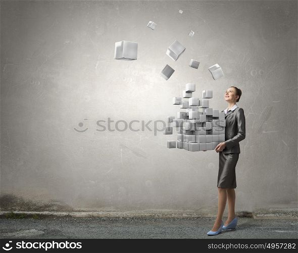 Modern technology integration concept. Attractive businesswoman shows 3D cube illustration as symbol of modern technology