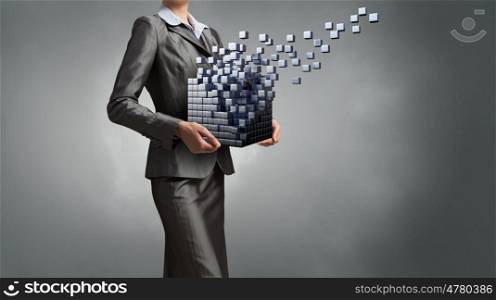 Modern technology integration concept. Attractive businesswoman shows cube as symbol of modern technology
