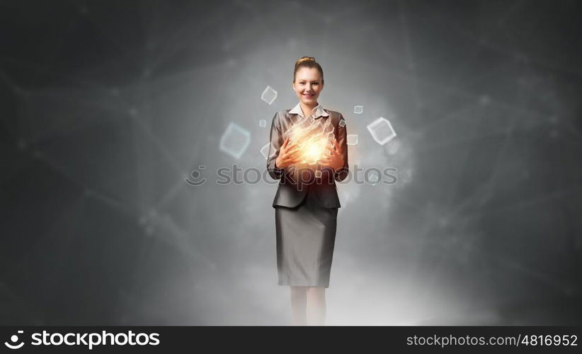 Modern technology integration concept. Attractive businesswoman shows cube as symbol of modern technology