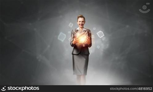 Modern technology integration concept. Attractive businesswoman shows cube as symbol of modern technology
