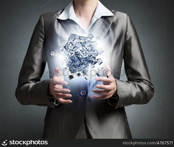 Modern technology integration concept. Close view of businesswoman shows cube as symbol of modern technology