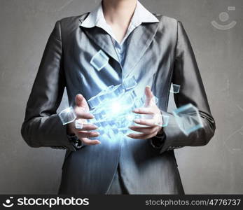 Modern technology integration concept. Close view of businesswoman shows cube as symbol of modern technology