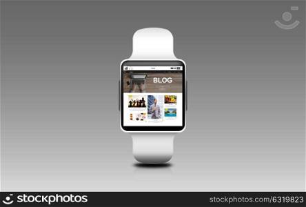 modern technology, internet, object and blogging concept - close up of black smart watch with blog web page on screen over gray background. close up of smart watch with blog page on screen