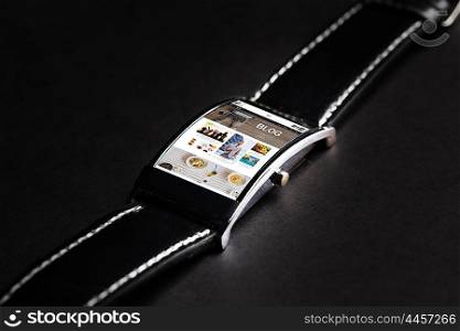 modern technology, internet, object and media concept - close up of black smart watch with blog web page on screen