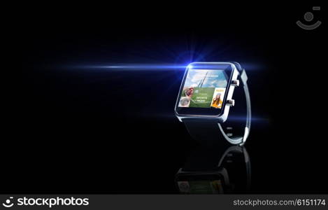 modern technology, mass media, object and media concept - close up of black smart watch with news application on screen