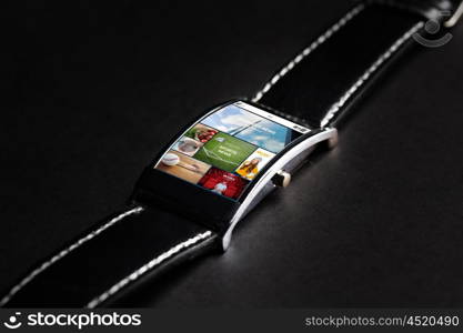 modern technology, object and media concept - close up of black smart watch with internet news on screen