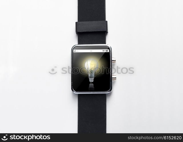 modern technology, object and media concept - close up of black smart watch with light bulb on screen