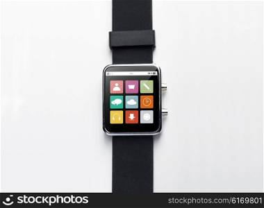modern technology, object and media concept - close up of black smart watch with menu icons on screen