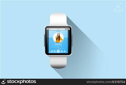 modern technology, object and media concept - close up of black smart watch with music player on screen over blue background. close up of smart watch with music