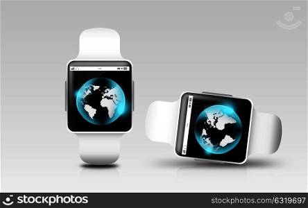 modern technology, object, network, responsive design and communication concept - smart watches with earth globe on screen over gray background. smart watches with earth globe on screen