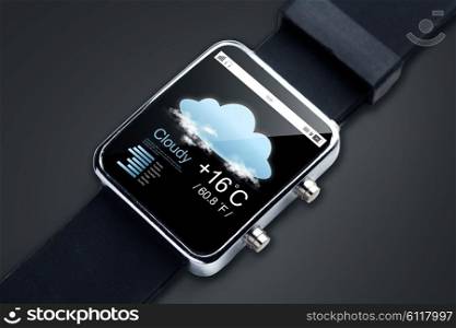modern technology, objectm, weather and media concept - close up of black smart watch with forecast app and air temerature on screen