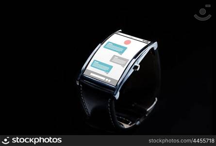 modern technology, online communication, object and media concept - close up of black smart watch with messenger application on screen