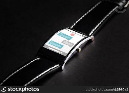 modern technology, online communication, object and media concept - close up of black smart watch with messenger application on screen