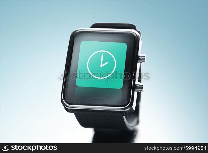 modern technology, time, object and media concept - close up of black smart watch with clock icon on screen over blue background