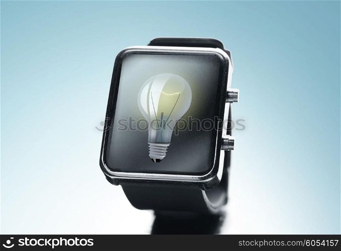 modern technology, time, object and media concept - close up of black smart watch with light bulb on screen over blue background