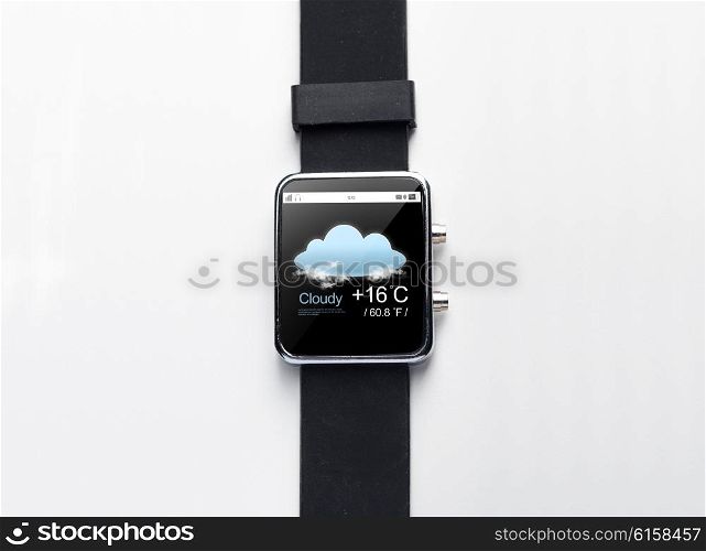 modern technology, weather cast, object and media concept - close up of black smart watch with forecast application