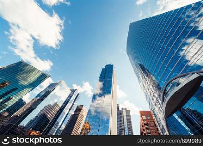 Modern tower buildings or skyscrapers in financial district with cloud on sunny day in Chicago, USA. Construction industry, business enterprise organization, or communication technology concept