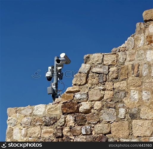 Modern video surveillance system on the old walls of the crusader fortress of Karak, Jordan, middle east