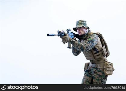 modern warfare american marines soldier in action while sneaking and aiming  on laseer sight optics  in combat position and  searching for target in battle