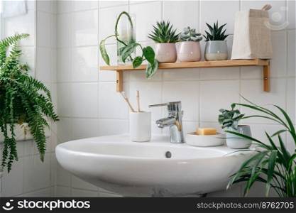 Modern white bathroom with bamboo shelf and many green plants. Home comfort zone. Wellness and yero waste. Modern white bathroom with bamboo shelf and plants